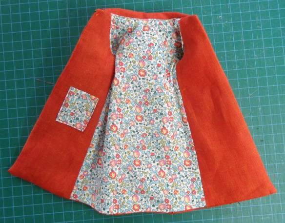 Trench Setting coat designed by Hankie Chic for Silkstone Barbie, sewn in orange shot linen by Deborah Cooke