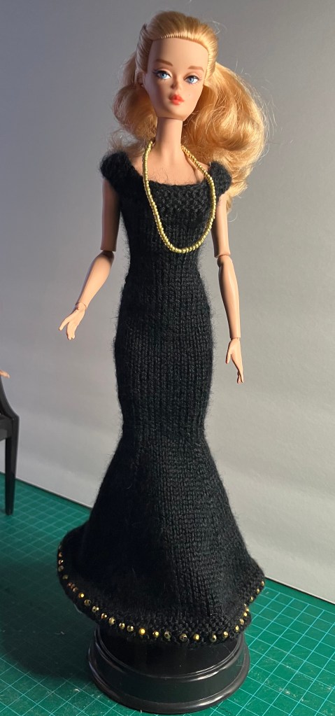 #619 Blue glitter dress from Stickatillbarbie.se knit in a black acrylic yarn by Deborah Cooke