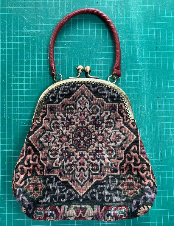 first purse with metal handle made by Deborah Cooke